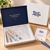 Paint Me Like kit packaging with canvas, paints and three brushes